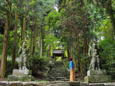 Japan temple nature | Japan City Tour | Travel agency in Tokyo A woman standing in front of a temple in a Japanese forest