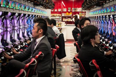 pachinko in Japan | Japan City Tour | Travel agency in Tokyo Men in suit playing pachinko. Pachinko is one of the legal forms of gambling in Japan